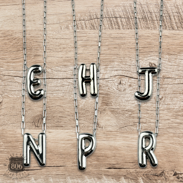 Silver letter pendant on necklace, initial monogram